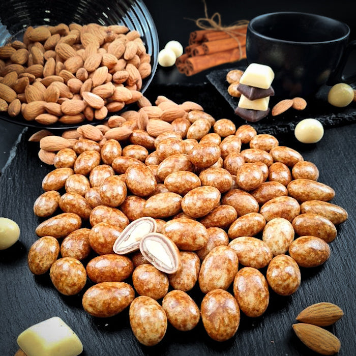 Kanēļu dražejas ar mandelēm baltā beļģu šokolādē