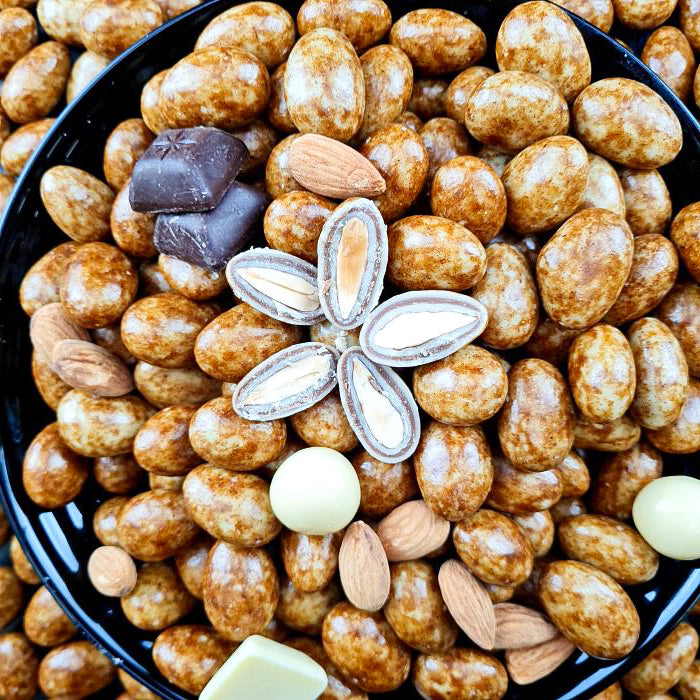 Kanēļu dražejas ar mandelēm baltā beļģu šokolādē